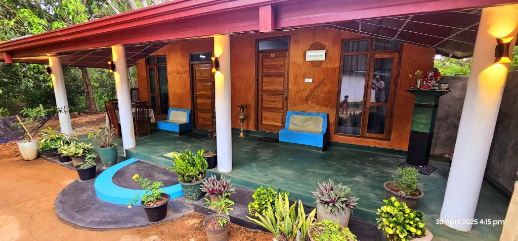 a house with plants on the front of it at Dilanya Homestay in Habarana
