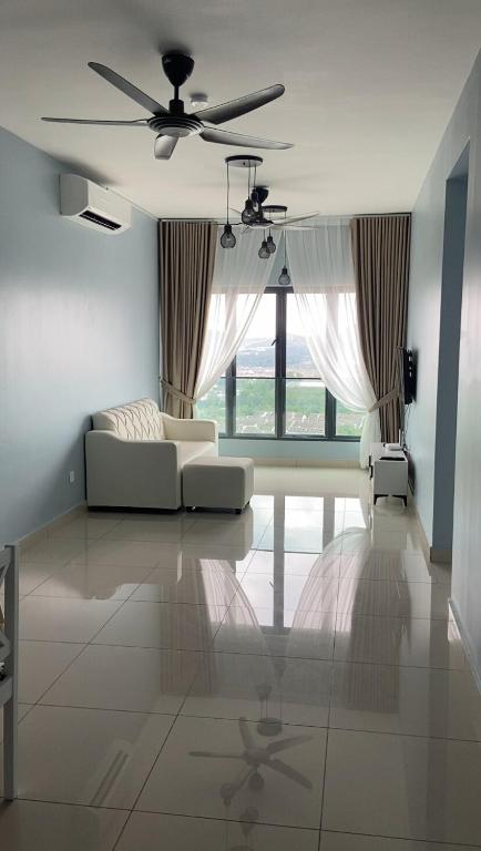 a living room with a couch and a ceiling fan at Tulips Cozy Homestay For You in Shah Alam