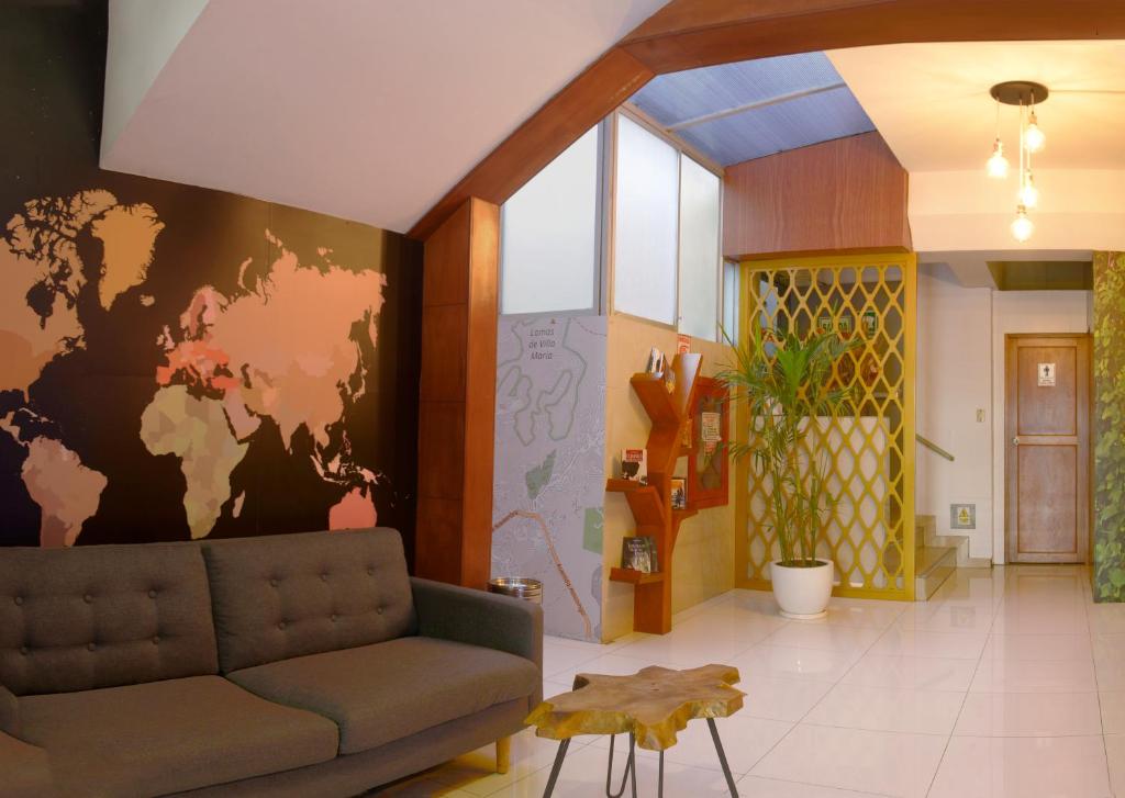 a living room with a couch and a world mural at Hotel Lima City in Lima