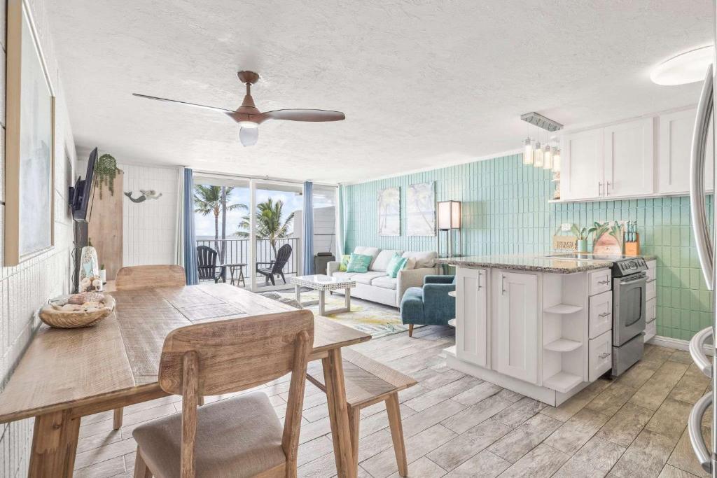 a kitchen and living room with a table and chairs at Beautiful Condo Right on the Beach in Hauula
