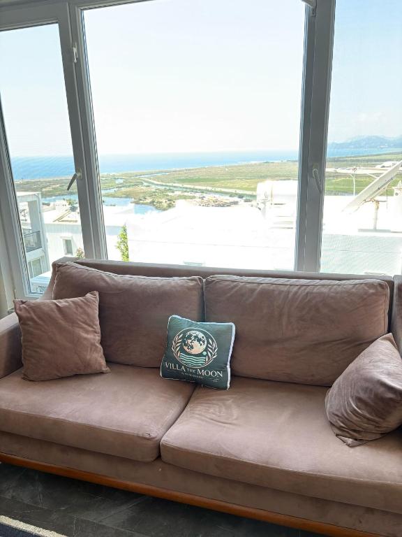 a pillow sitting on a couch in front of a window at Villa the Moon in Dalaman