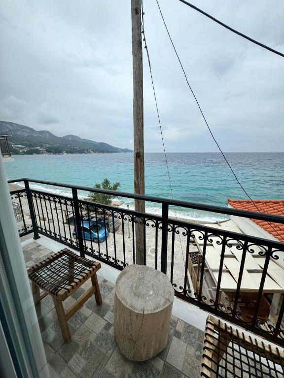 a balcony with a table and a view of the ocean at Bleu Mati in Kokkari