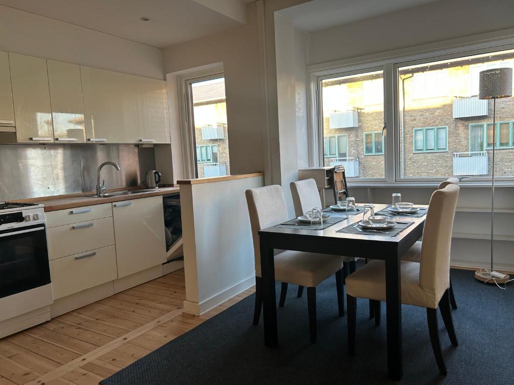 a kitchen with a table and chairs in a kitchen at Harbour Residence in Copenhagen