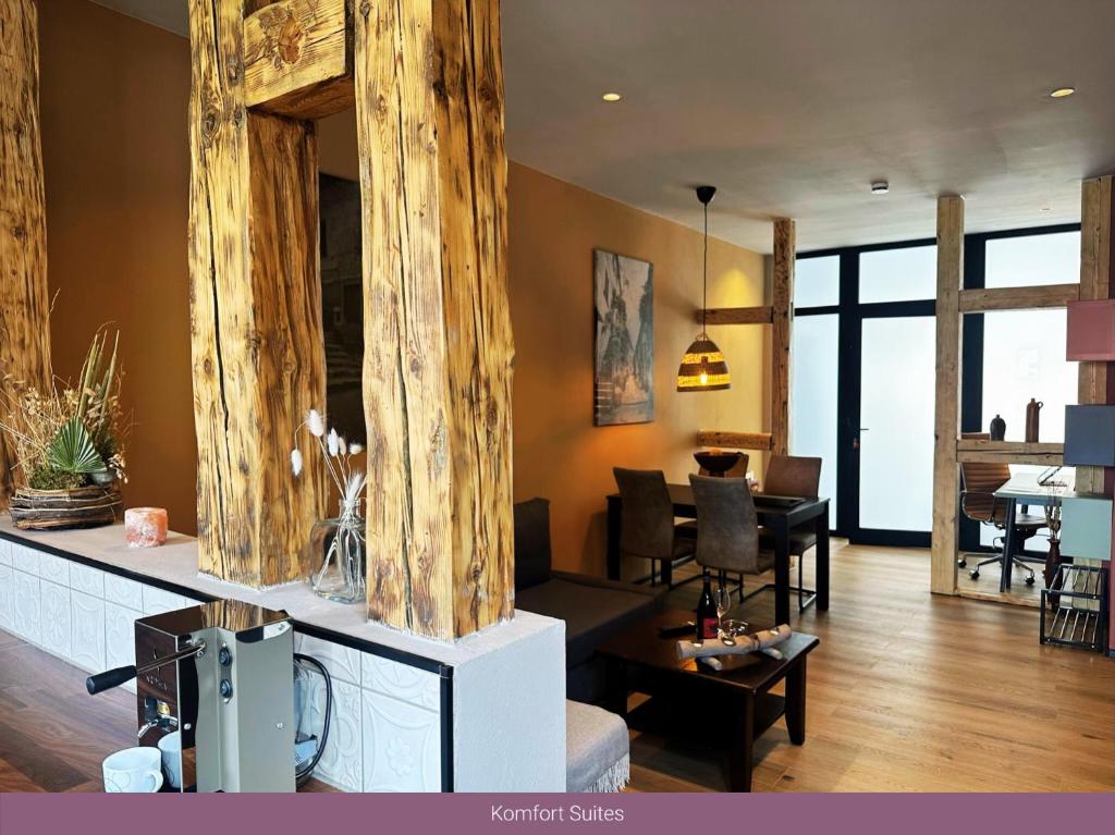 a living room with a couch and a dining room at Trattoria & Apartments - Casa da Enzo in Goslar