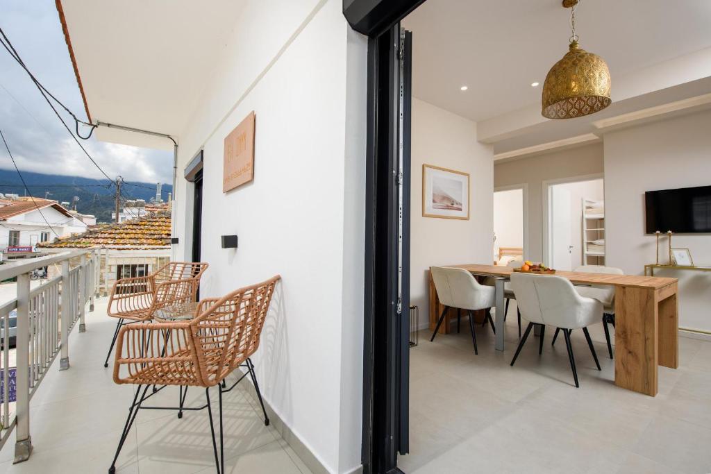 a dining room with a table and chairs on a balcony at EvA OMMM in Limenas