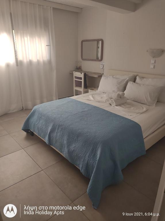 A bed or beds in a room at Irida Holiday Apartments