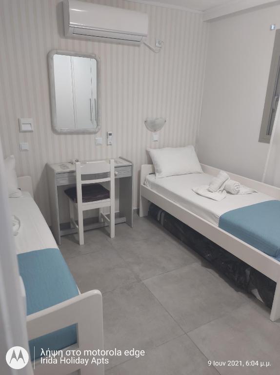 A bed or beds in a room at Irida Holiday Apartments