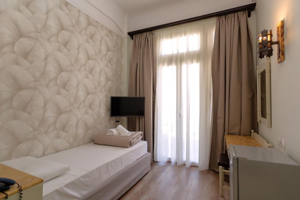 Postel nebo postele na pokoji v ubytování Hotel Kosmopolit