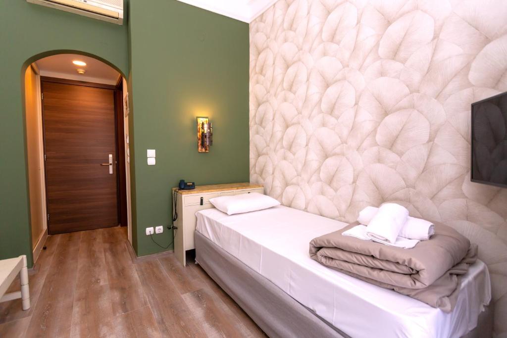 Postel nebo postele na pokoji v ubytování Hotel Kosmopolit