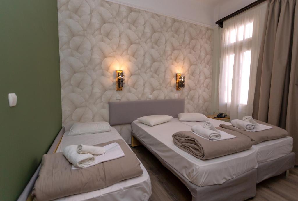 Postel nebo postele na pokoji v ubytování Hotel Kosmopolit