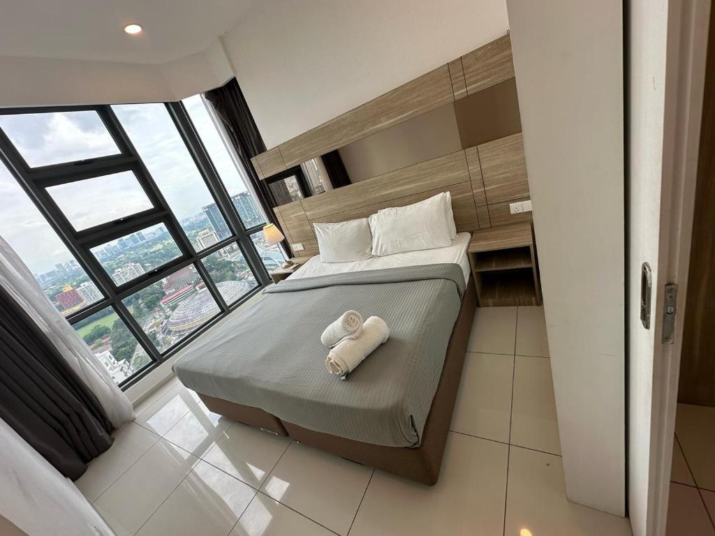 a bedroom with a bed with a towel on it at The Roberstson family suite with city views in Kuala Lumpur