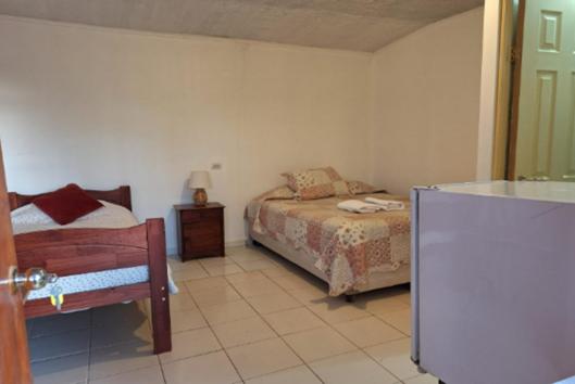 Postel nebo postele na pokoji v ubytování Hostal Las Kañas