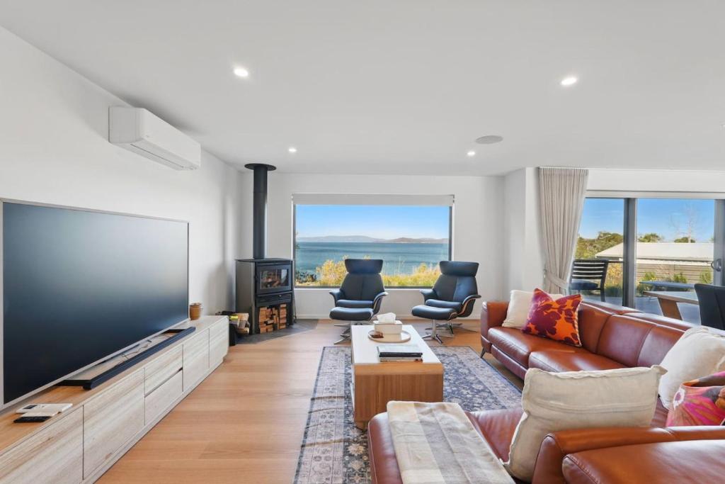 a living room with a large flat screen tv at Modern Coastal Retreat and Hot Tub in Carlton