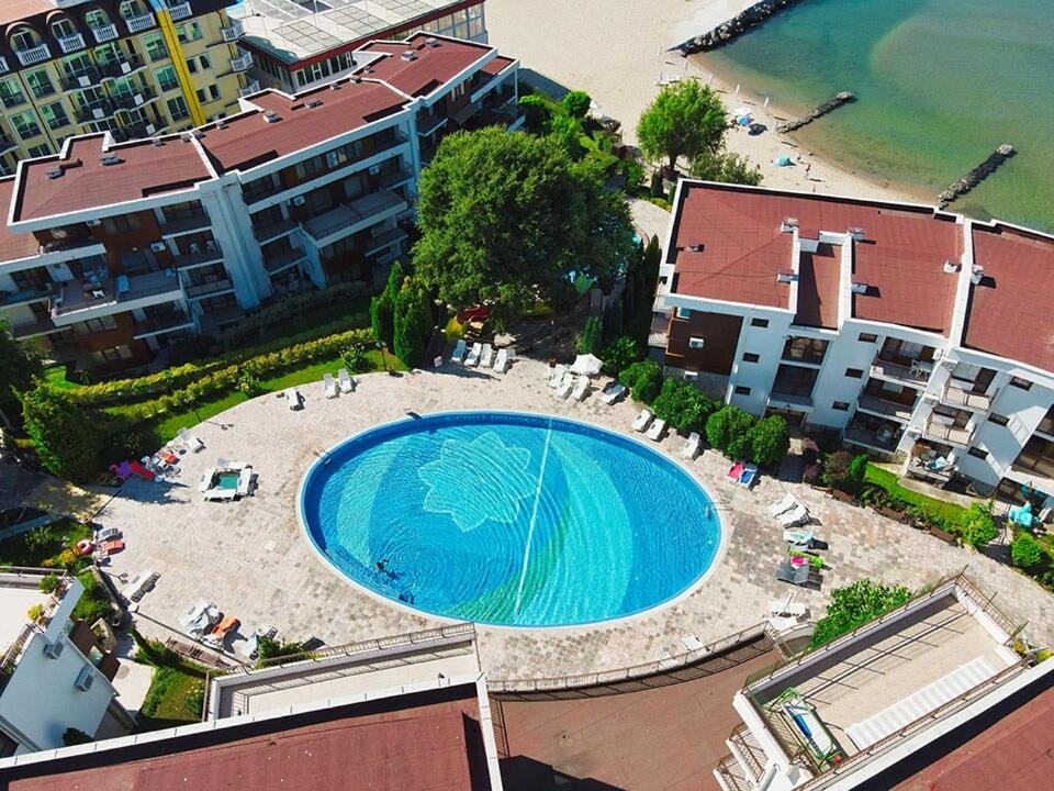 an overhead view of a swimming pool next to a beach at Beachfront, 2 Bed with Sea Views in Elenite
