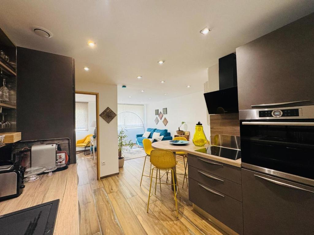 a kitchen with a counter and a table with chairs at Smp BLING BLING in Toulon