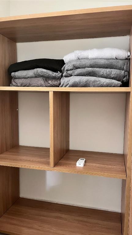 a wooden shelf with some towels on it at Alugo casa 5 minutos da praia de carro in São Sebastião