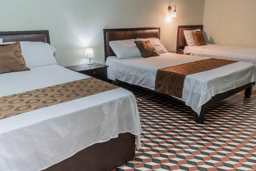 Postel nebo postele na pokoji v ubytování Hotel Cafetto
