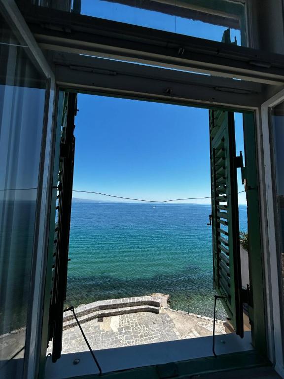 a view of the ocean from a window at room 10 m from the sea in Opatija