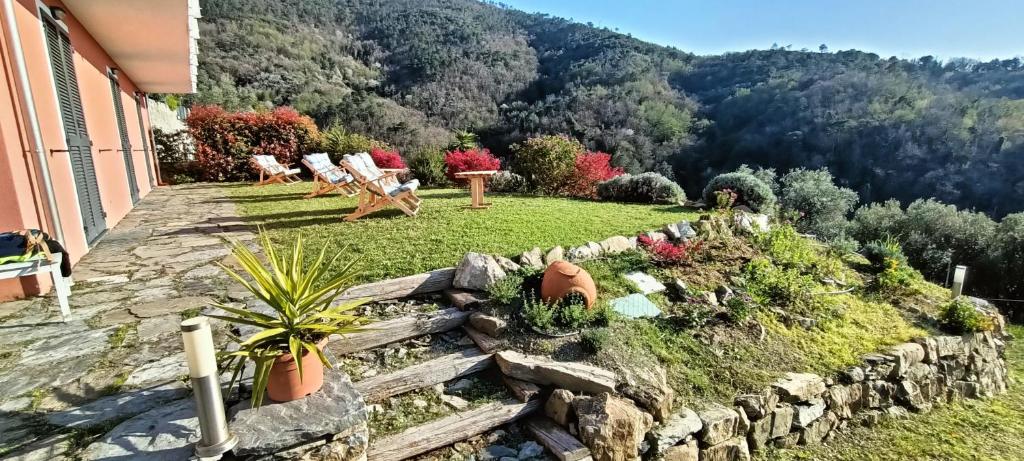 un giardino con un muro in pietra e alcune piante di Agriturismo Orto dei Rolli a Moneglia