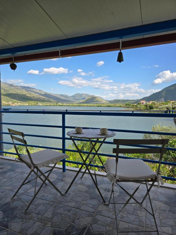 two chairs and a table on a balcony with a view at Lake View Loft 5 in Mursi