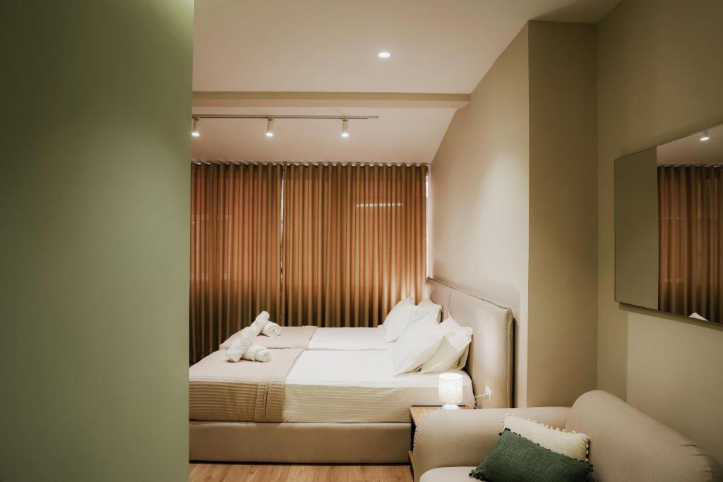a bedroom with a bed and a couch at Elite Guesthouse in Tirana