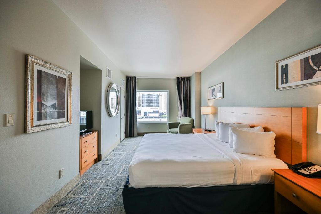 a hotel room with a bed and a television at StripViewSuites at Platinum in Las Vegas