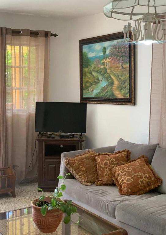 TV a/nebo společenská místnost v ubytování Hermes Casa Len
