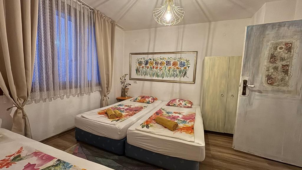 una camera da letto con due letti e una finestra di Guest house Hei taka a Sozopol