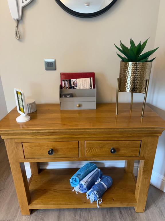 a wooden table with towels on a shelf at The Duplex Margate with Deck & Living Space Air Conditioning in Margate