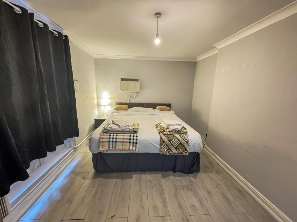 a bedroom with a large bed in a room at Queensborough Apartment, Central London in London