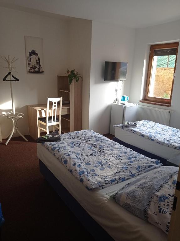 Postel nebo postele na pokoji v ubytování Penzion Pralinka