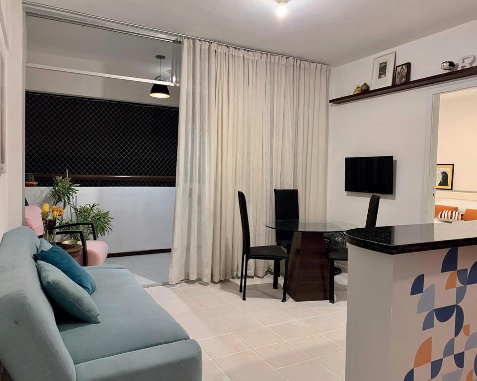 a living room with a couch and a table at Quarto e Sala Temporada no Rio Vermelho in Salvador