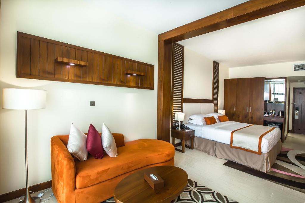 a hotel room with a bed and a couch at Western Hotel - Madinat Zayed in Madīnat Zāyid