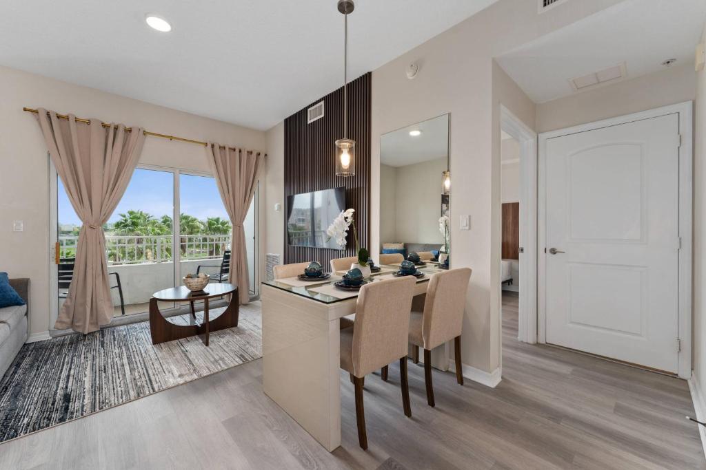a kitchen and dining room with a table and a living room at 2 Units Together Kitchen Great Location in Orlando