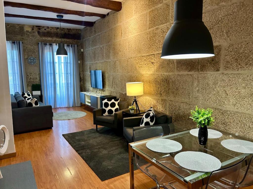 a living room with a glass table and chairs at Ubicacion inigualable in Vigo