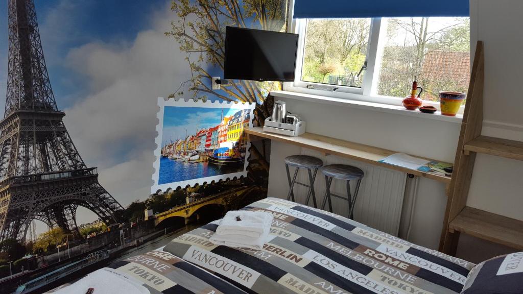 a bedroom with a mural of the eiffel tower at B&B Aangenaam - Olde Horst Diever in Diever