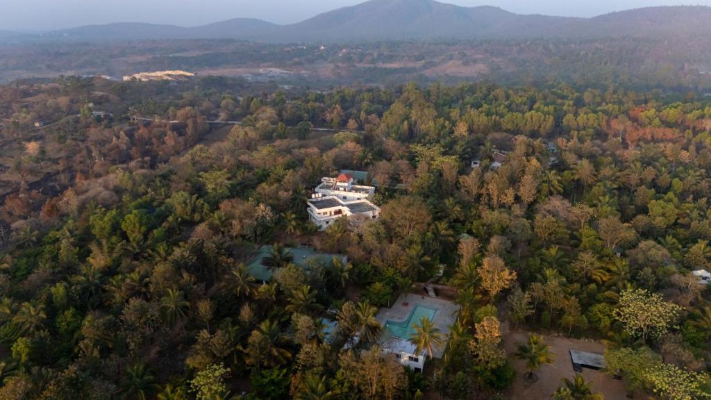 an aerial view of a house in the woods at The Peacock Village Eco Resort & Spa in Amrutūr