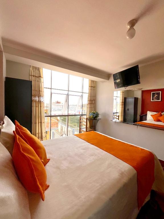 Postel nebo postele na pokoji v ubytování Hostal Bryan