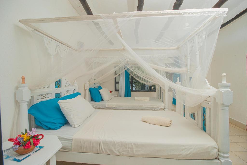 Postel nebo postele na pokoji v ubytování Sunny garden rooms Watamu