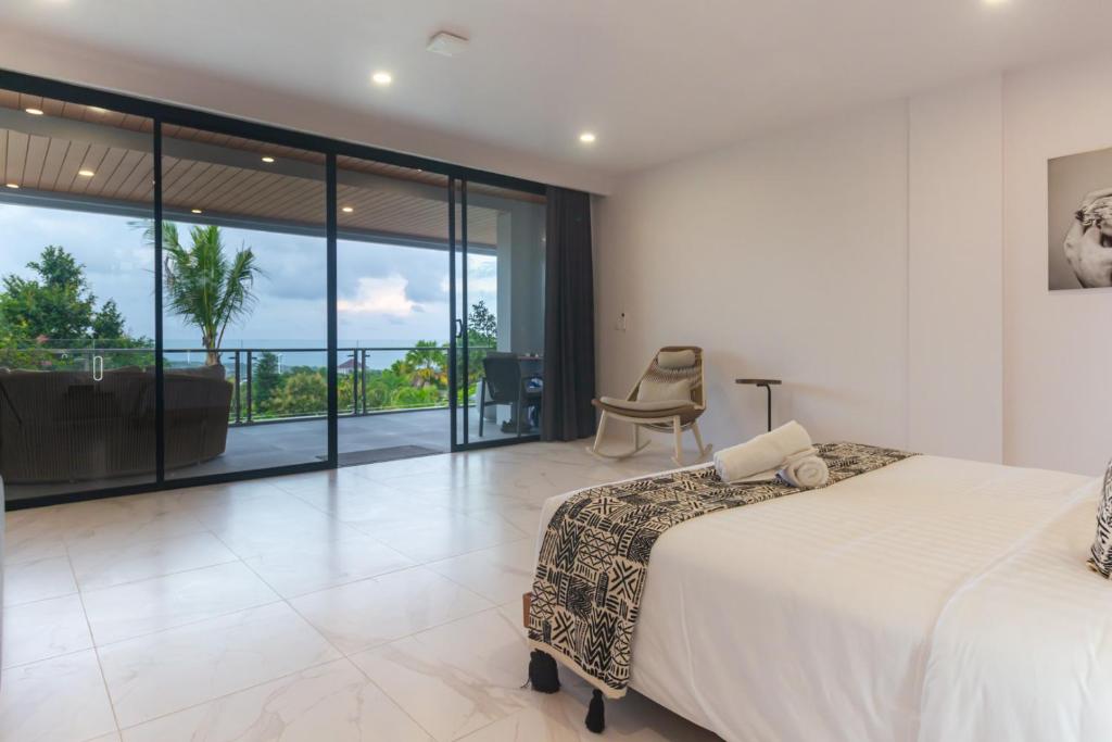a bedroom with a bed and a view of the ocean at Gandum Uluwatu Luxury Boutique Stay - Gandum Villa Complex in Uluwatu
