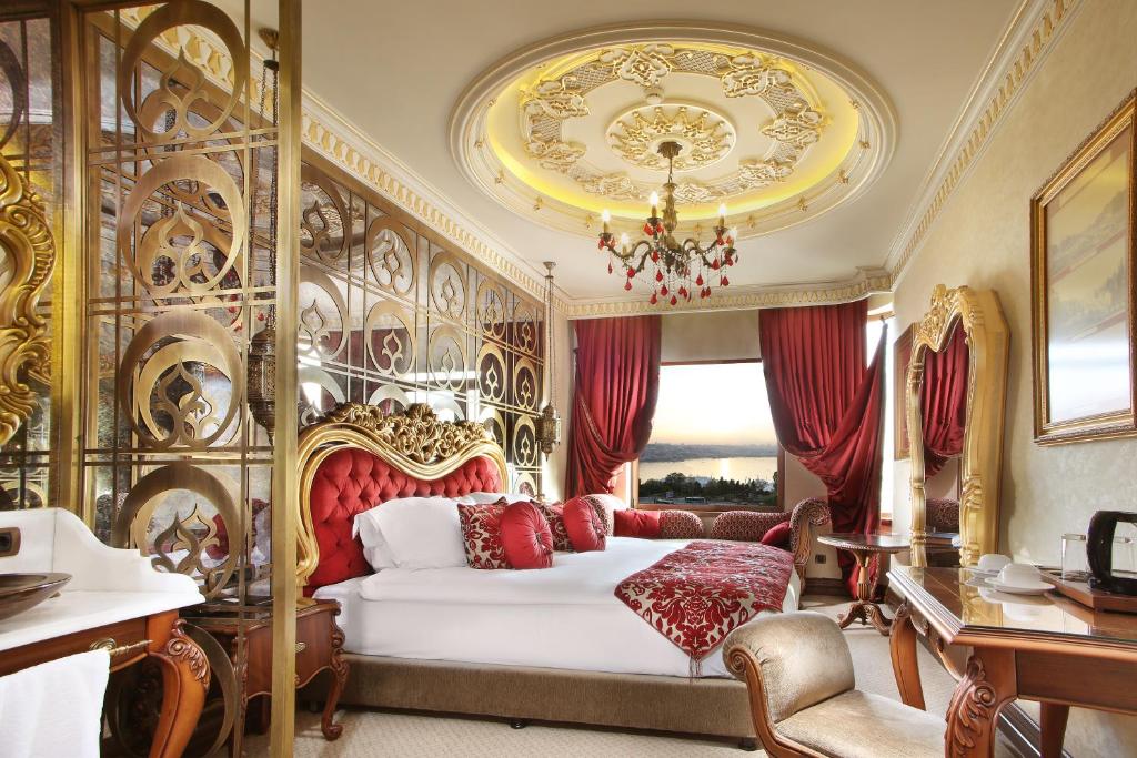 a bedroom with a bed and a chandelier at Daru Sultan Hotels Galata in Istanbul