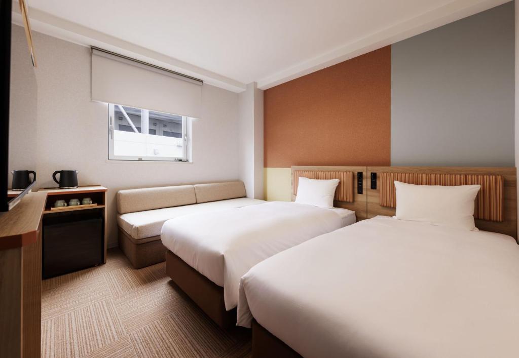 Postel nebo postele na pokoji v ubytování CVS Bay Hotel
