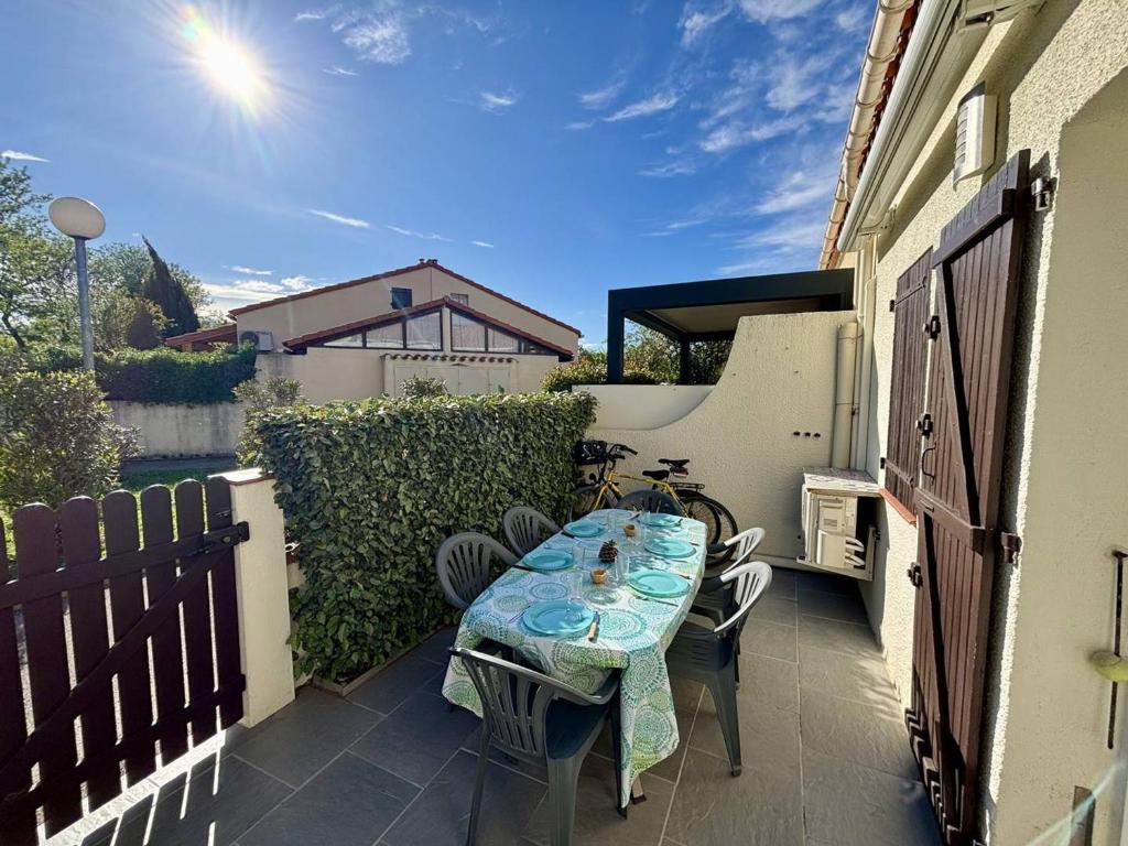 un patio avec une table et des chaises sur un balcon dans l'établissement T2 Mezzanine Climatisé - 250m Mer - Argelès-sur-Mer - FR-1-388-236, à Argelès-sur-Mer