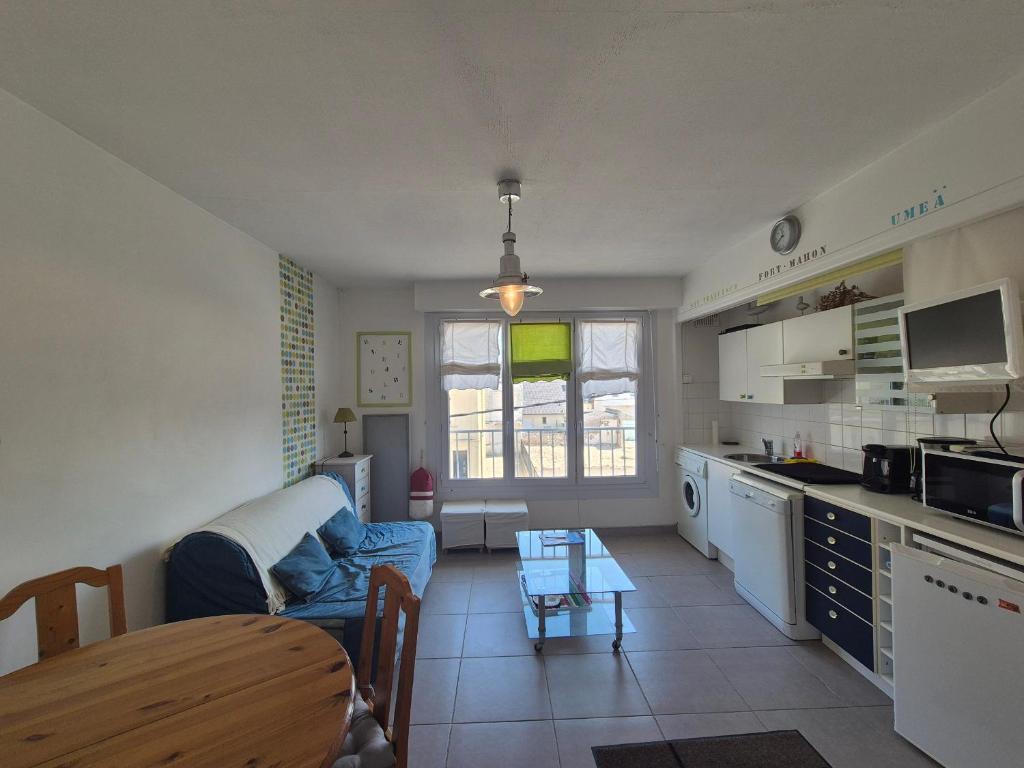 une cuisine et un salon avec un canapé et une table dans l'établissement Appartement 3 Pers à 100m de la mer, Animaux Bienvenus - FR-1-482-156, à Fort-Mahon-Plage