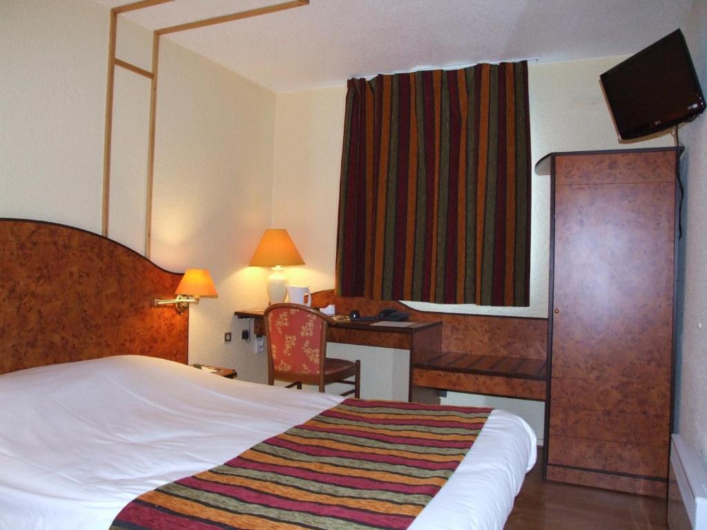 Postel nebo postele na pokoji v ubytování Logis Cottage Hôtel