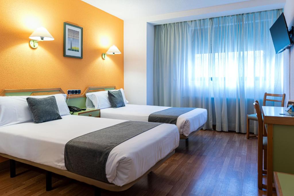 Postel nebo postele na pokoji v ubytování Hotel Alda Guijuelo