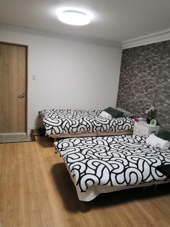 Säng eller sängar i ett rum på Nippori Osaka Nishi-Tengachaya Guesthouse西天下茶屋アパートメント