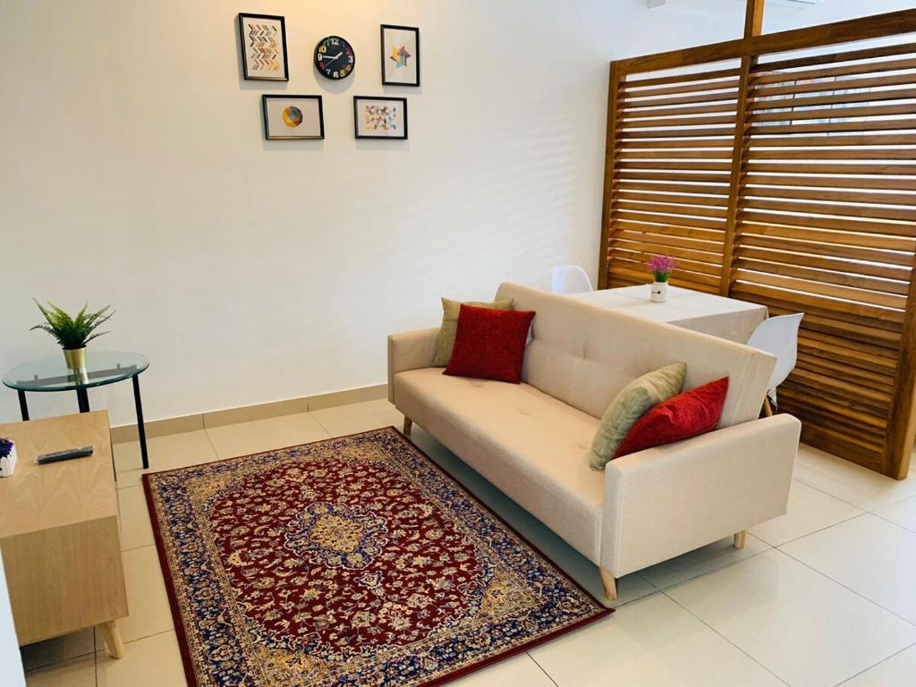 a living room with a couch and a rug at Cozy 2B at Midhills Genting in Genting Highlands