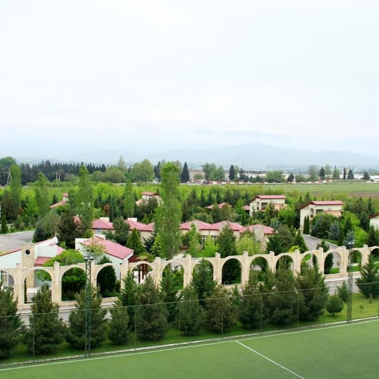 an aerial view of a building and a tennis court at Arena Hotel Gazakh in Qazax