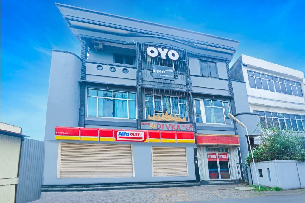 a large building with avs pharmacy signs in front of it at Hotel O Bandar Lampung Near Teropong Kota Bukit Cindy Formerly Divka Residence in Tanjungkarang